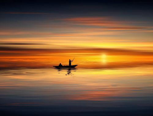 photo of people on rowboat during sunset