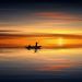 photo of people on rowboat during sunset