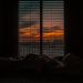 crumpled blanket in dark room at sunset