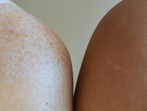 shoulders of multiracial models against light wall
