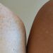shoulders of multiracial models against light wall
