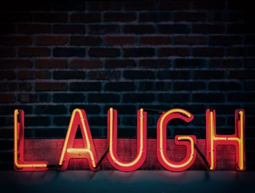 laugh neon light signage turned on