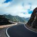 black asphalt road near cliff mountain