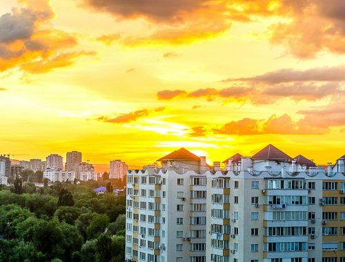 gray white high rise building during sun set