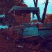 rusty brown and gray boat near trees and body of water