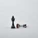 two silver chess pieces on white surface