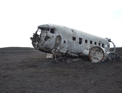gray airplane on seashore
